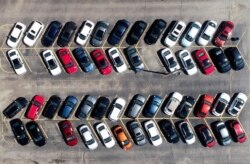 Cars are parked in an auto dealer lot Wednesday, April 15, 2020, in Green Park, Mo. U.S. retail sales recorded a record drop in March, with auto sales down 25.6%, as the coronavirus outbreak closed thousands of stores and shoppers stayed home.