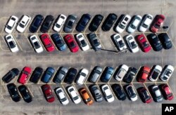 Cars are parked in an auto dealer lot Wednesday, April 15, 2020, in Green Park, Mo. U.S. retail sales recorded a record drop in March, with auto sales down 25.6%, as the coronavirus outbreak closed thousands of stores and shoppers stayed home.