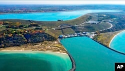 This undated photo provided by Consumers Energy shows an aerial view of the Ludington Pumped Storage Plant near Ludington, Mich. Advocates of pumped storage call such facilities the "world's largest batteries." (AP Photo/Consumers Energy)