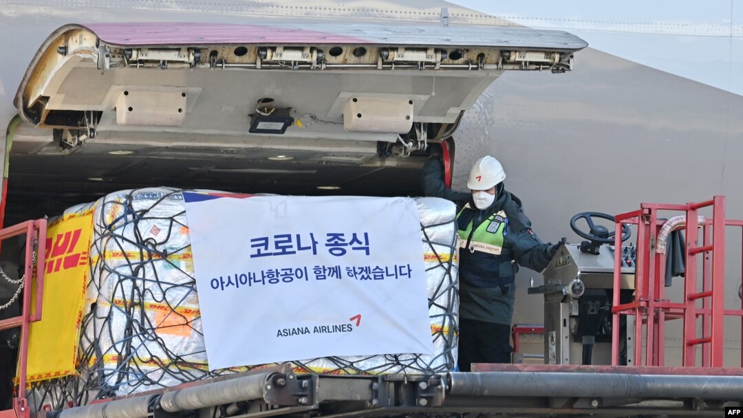 A South Korean worker unloads cargo containing Pfizer's antiviral COVID-19 pill, Paxlovid, at a cargo terminal of the Incheon International Airport in Incheon on Jan. 13, 2022