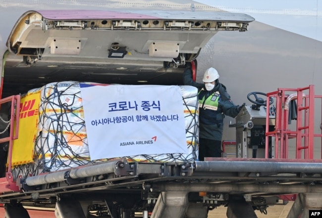 FILE - A South Korean worker unloads cargo containing Pfizer's antiviral COVID-19 pill, Paxlovid, at a cargo terminal of the Incheon International Airport in Incheon on Jan. 13, 2022. (Photo by JUNG YEON-JE / POOL / AFP)