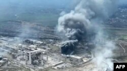 This handout video grab taken from footage released by Mariupol City Council on April 19, 2022, shows clouds of smoke billowing above Azovstal steel plant, as Russia continues its push to capture the besieged port city of Mariupol.