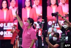 FILE - The Philippines' Vice President and presidential candidate Leni Robredo greets supporters during a campaign rally in the business district of Pasig city, suburban Manila, March 20, 2022.