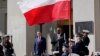 Defense Secretary Lloyd Austin, right, stands with Polish Defense Minister Mariusz Błaszczak, left, as the National Anthem is played during an arrival ceremony at the Pentagon in Washington, Apr. 20, 2022. 