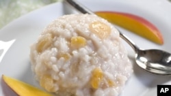 This Oct. 5, 2010 photo shows basmati-almond rice pudding with mango. The rich flavor of almond milk makes this rice pudding a wonderful non-dairy side. (AP Photo/Larry Crowe)