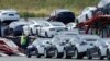 FILE - In this May 13, 2020, photo, Tesla cars are loaded onto carriers at the Tesla electric car plant in Fremont, Calif. 