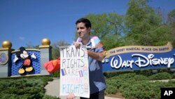 Nicholas Maldonado protests Disney's stance on LGBTQ issues while he participates in an employee walkout at Disney World on March 22, 2022.