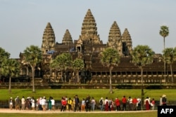 FILE: This picture taken on April 7, 2022 shows tourists visiting the Angkor Wat temple complex, a UNESCO World Heritage Site, in Siem Reap province.