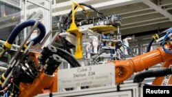 FILE: Machines are seen on a battery tray assembly line during a tour at the opening of a Mercedes-Benz electric vehicle Battery Factory, marking one of only seven locations producing batteries for their fully electric Mercedes-EQ models, in Woodstock, Alabama, on March 15, 2022.