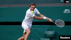 FILE - Russia's Daniil Medvedev in action during his third round match against Croatia's Marin Cilic, Wimbledon, July 3, 2021.