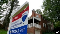 FILE: A "For Sale" sign is displayed outside a home in Mount Lebanon, Pa., on Tuesday, Sept. 21, 2021.