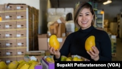 Wimwipha Chaiun, owner of food wholesaler ViPa Foods Corp, presents the imported mangoes at the company's warehouse in Los Angeles, California