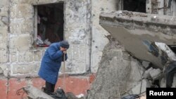 A woman cries as she tries to find a body of her son among debris of a residential building destroyed during Russia’s invasion in the town of Borodianka, Kyiv region, Ukraine on April 9, 2022.
