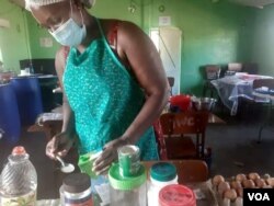 A woman at work in Bulawayo, Zimbabwe, learning how to cook domestic and commercial cakes and others foodstuffs