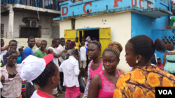 Students who can no longer attend schools and universities because the government temporarily closed them due to Ebola, take to the streets to protest, at NGO headquarters, Monrovia, Liberia, Sept. 29, 2014. (Benno Muchler/VOA)