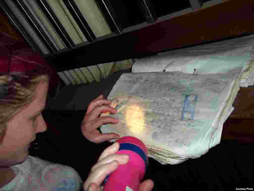 A GPS member pores over old documents during a probe of an abandoned hospital near Johannesburg where they recorded a very loud noise “like a man that took in his breath. We have no logical explanation for that sound.” (Photo Courtesy the Gauteng Paranorm