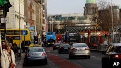 Workers make their way home from work in Dublin city center, Ireland, Dec. 13, 2013.