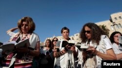 Jewish women activists, members of the Women of the Wall group, pray during a monthly prayer session at a spot a short distance from Western Wall plaza in Jerusalem's Old City, July 8, 2013.