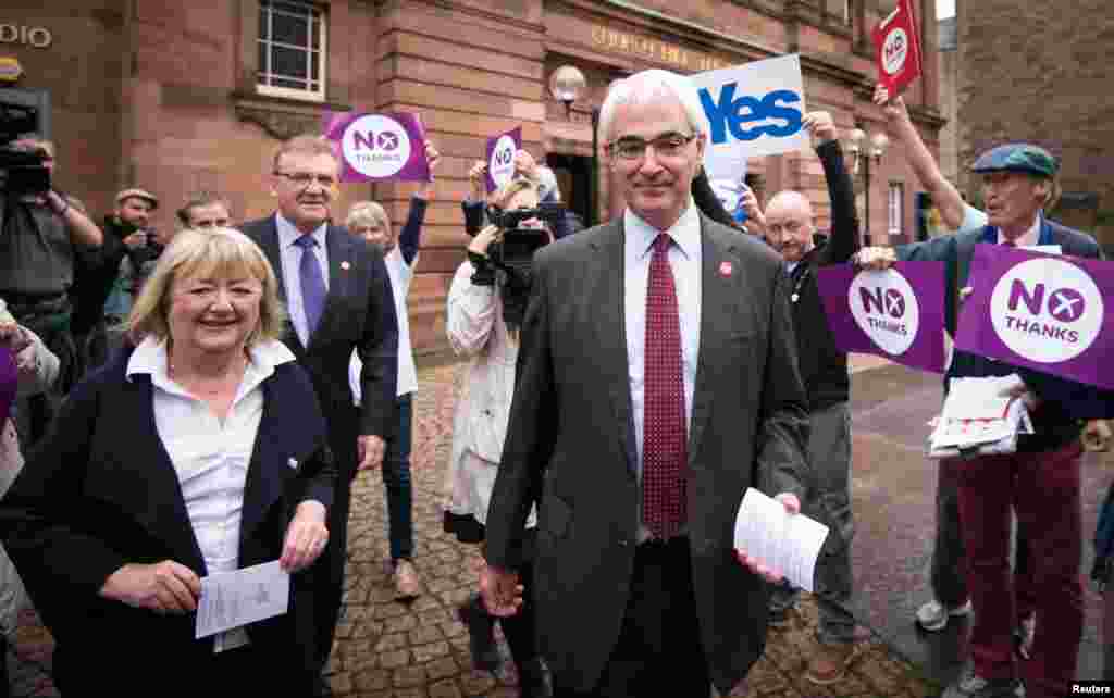 Former Chancellor of the Exchequer and leader of the Better Together campaign, Alistair Darling, walks with his wife Maggie outside the polling station at the Church Hill Theatre in Edinburgh, Scotland, Sept. 18, 2014.