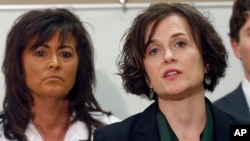 FILE - Minneapolis Police Chief Janee Harteau, left, listens as Mayor Betsy Hodges addresses a news conference, March 30, 2016. Harteau resigned at the mayor's request after the shooting death of an Australian by a Minneapolis police officer.