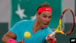 Spain's Rafael Nadal plays a shot against Serbia's Novak Djokovic in the final match of the French Open tennis tournament at the Roland Garros stadium in Paris, France, Oct. 11, 2020.