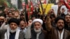 Shiite Muslims hold placards and shout during a protest march against the sectarian attacks in the Kurram district in Parachinar, the mountainous Khyber Pakhtunkhwa province, in Lahore, Pakistan, Nov. 22, 2024. 