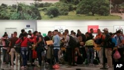 Cuban migrants wait to check-in at the Daniel Oduber Quiros International Airport in Liberia, Costa Rica, Jan. 12, 2016.