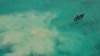 FILE - In this photo provided by the Philippine Coast Guard, a Chinese service boat searches for giant clams in the Scarborough Shoal, in the disputed South China Sea, on April 22, 2019. Five nations held joint maritime exercises in the sea on Sept. 28, 2024.