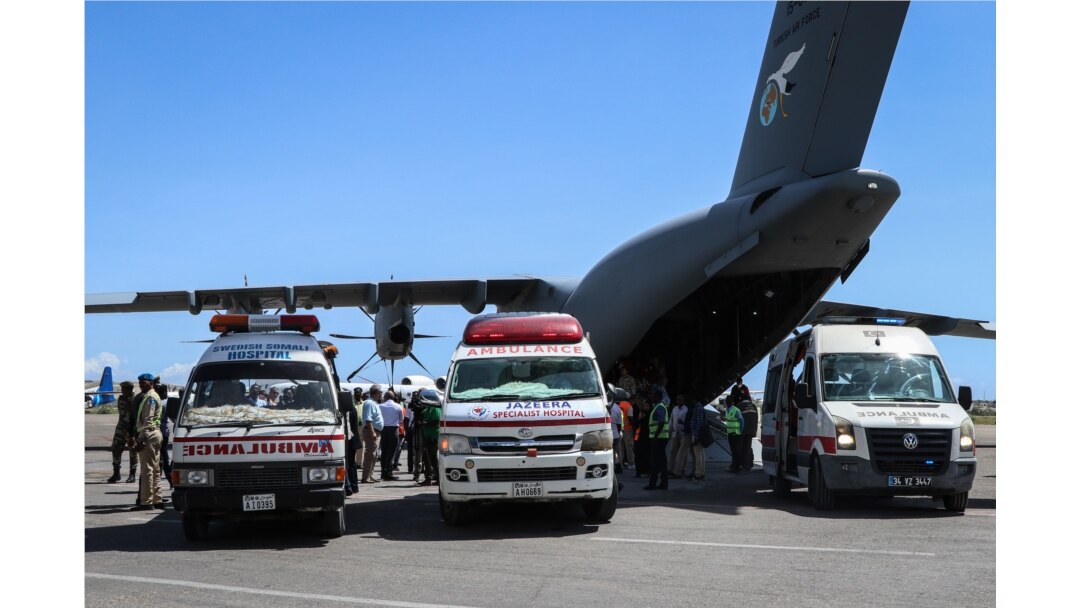 Ambulans-ambulans yang membawa korban luka-luka serangan bom pada 28 Desember di Mogadishu, terparkir di sebelah pesawat Angkatan Udara Turki, di Bandara Internasional Adan Adde, 29 Desember 2019. (Foto: AFP)