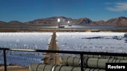 FILE - Heliostats reflect sunlight onto boilers in towers at the Ivanpah Solar Electric Generating System in the Mojave Desert near the California-Nevada border Feb. 13, 2014. Google is a partner in the project.