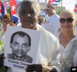 Woman holds a picture of Orlando Zapata Tamayo, who died in February after an 85-day hunger strike, at a rally in LIttle Havana, Miami, 25 March 2010
