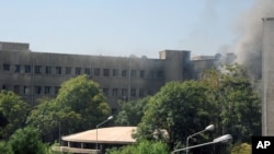 This photo released by the Syrian official news agency SANA, shows smoke rising from Syria's army command headquarters in Damascus, Syria, Sept. 26, 2012