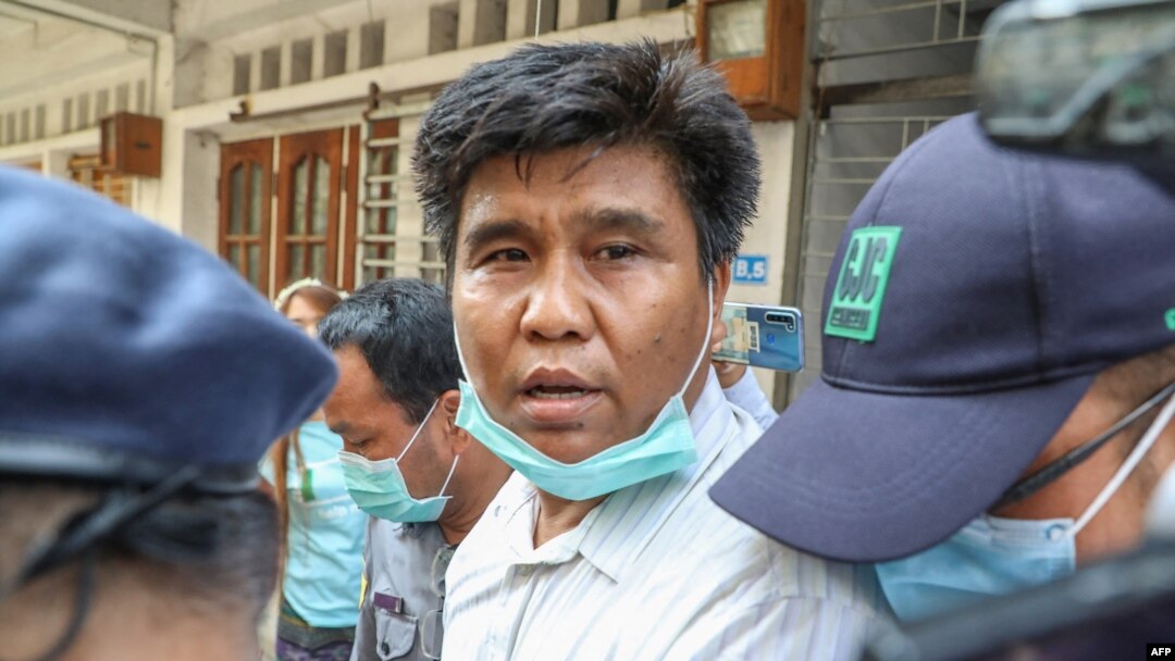 Voice of Myanmar editor-in-chief Nay Myo Lin is escorted from his home by police to court in Mandalay on March 31, 2020.