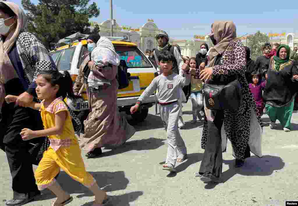 Women with their children try to get inside Hamid Karzai International Airport in Kabul, Afghanistan.