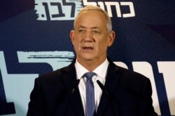 FILE - Benny Gantz, leader of Blue and White party, delivers a statement at the start of his party faction meeting in Tel Aviv, Israel, Sept. 26, 2019.