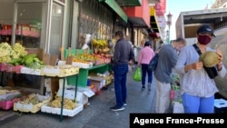 FILE - People wear masks as they shop in the Chinatown neighborhood of San Francisco, California, July 31, 2020.