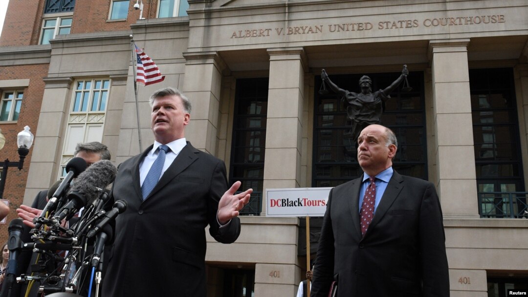 Defense attorneys Richard Westling, (behind microphones), Kevin Downing and Thomas Zehnle speak to the media in front of the U.S. District Courthouse after the verdicts were read in former Trump campaign manager Paul Manafort's trial, in Alexandria, Virginia, Aug. 21, 2018.
