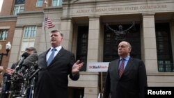 Defense attorneys Richard Westling, (behind microphones), Kevin Downing and Thomas Zehnle speak to the media in front of the U.S. District Courthouse after the verdicts were read in former Trump campaign manager Paul Manafort's trial, in Alexandria, Virginia, Aug. 21, 2018.