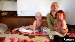 The children of Roma woman Sasha Ruseva (not pictured) rest inside their home in Nikolaevo, southern Bulgaria, Oct. 24, 2013. Ruseva is believed to have given birth to the girl named Maria, found by police in a Roma settlement in Greece on Oct. 16.