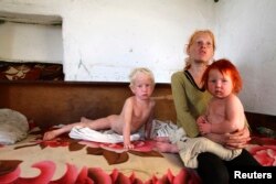 The children of Roma woman Sasha Ruseva (not pictured) rest inside their home in Nikolaevo, southern Bulgaria, Oct. 24, 2013. Ruseva is believed to have given birth to the girl named Maria, found by police in a Roma settlement in Greece on Oct. 16.