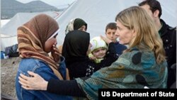 USAID Assistant Administrator Nancy Lindborg, center, talks with Syrian refugees during a recent visit to the Islahiye camp in Turkey.
