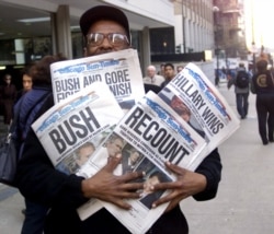 In this Nov. 8, 2000 photo, newspaper headlines reflect the suspense, drama and changes in following the presidential race between Vice President Al Gore and Texas Gov. George W. Bush.