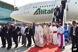 In this image provided by L’Osservatore Romano, Pope Francis arrives in Yangon, Myanmar, Nov. 27, 2017.