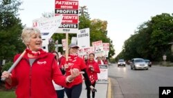 Mary Turner, president of the Minnesota Nurses Association, left, joins nurses striking, Sept. 12, 2022 outside North Memorial Health Hospital in Robbinsdale, Minn.