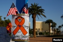 A sign is pictured at a makeshift memorial in the middle of Las Vegas Boulevard following the mass shooting in Las Vegas, Nevada, Oct. 4, 2017.