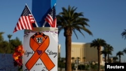 A sign is pictured at a makeshift memorial in the middle of Las Vegas Boulevard following the mass shooting in Las Vegas, Nevada, Oct. 4, 2017.