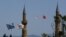 (From left to right) Greek and Cyprus' flags, a Turkish and Turkish Cypriot breakaway flags fly on a minaret of the Selimiye mosque, or Cathedral of St Sophia in divided capital Nicosia, Cyprus, April 26, 2021.