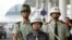 FILE - Chinese police patrol the Baiyun International Airport in Guangzhou, Aug. 5, 2004. 