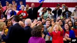 FILE - Democratic presidential candidate Hillary Clinton takes a group selfie after speaking at a get out the vote event at Transylvania University in Lexington, Ky., Monday, May 16, 2016.