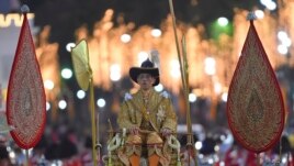 Thailand's King Maha Vajiralongkorn is transported on the royal palanquin by royal bearers during the Royal Procession outside the Grand Palace in Bangkok, Thailand, Thursday, Dec. 12, 2019. (AP Photo/Suganya Samnangjam)